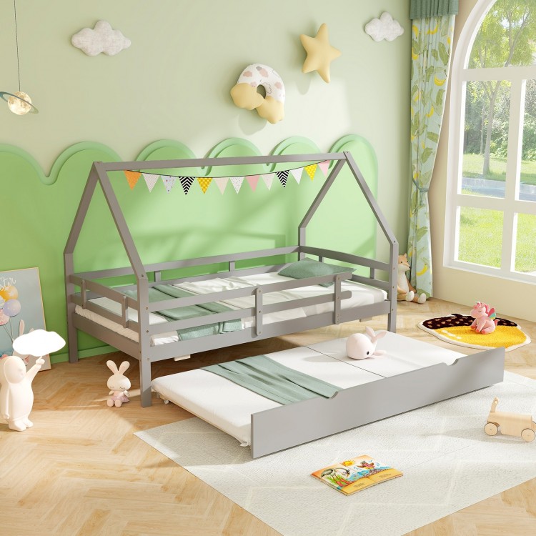 Twin house bed in gray with pull-out trundle, protective fence rails, perfect for children's sleepovers and safety.