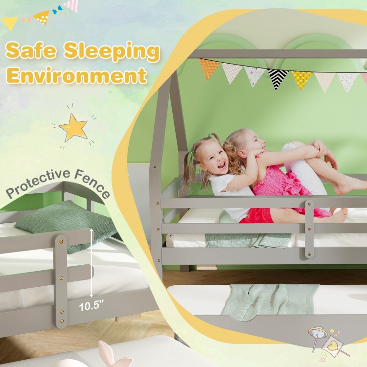 Twin house bed in gray with protective fence, featuring a pull-out trundle for extra sleeping space in a child's room.