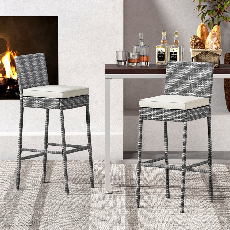 Set of 2 patio wicker barstools with soft seat cushions and cozy footrests, ideal for backyard or poolside use.
