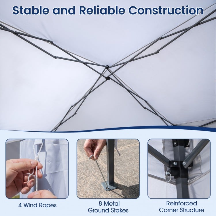 Close-up of the pop-up canopy tent's reinforced corner structure with metal stakes and wind ropes for secure setup.