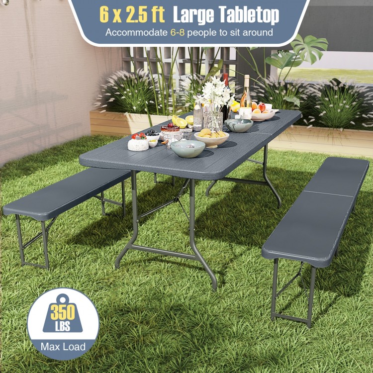 Gray 6 x 2.5 ft folding table with wood grain HDPE top, accommodating 6-8 people for outdoor picnics or indoor use.