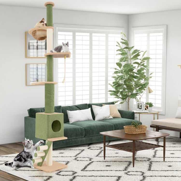 Floor to ceiling cat tree with adjustable height, cozy condo, and scratching posts for playful feline fun in green.