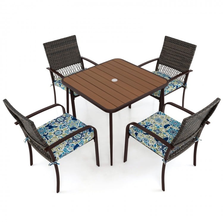 Square table with four cushioned rattan armchairs, perfect for outdoor dining and relaxation in your backyard or patio.