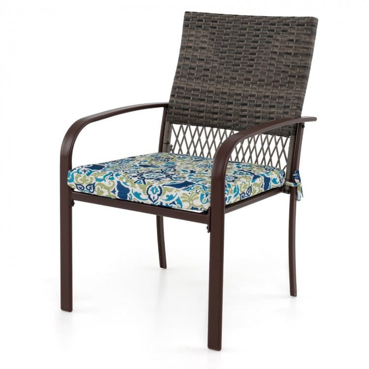 Cushioned rattan armchair with a breathable backrest and curved armrests, perfect for outdoor dining and relaxation.