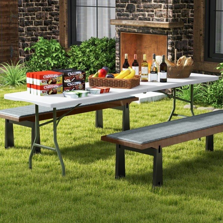 8 ft portable folding table with HDPE tabletop, ideal for outdoor use, set up for a picnic with food and drinks.