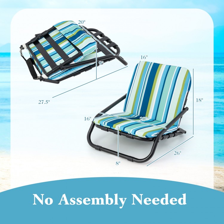 Low folding beach chair with blue striped cushion, lightweight aluminum frame, perfect for outdoor relaxation.