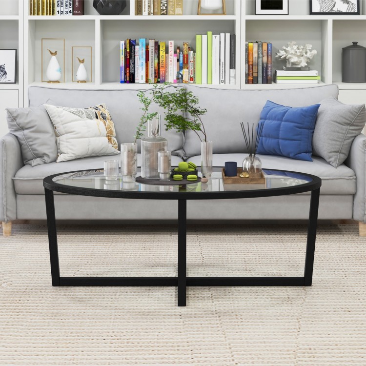 Oval glass coffee table featuring a black cross base and acacia wood legs, enhancing your living room with elegant.