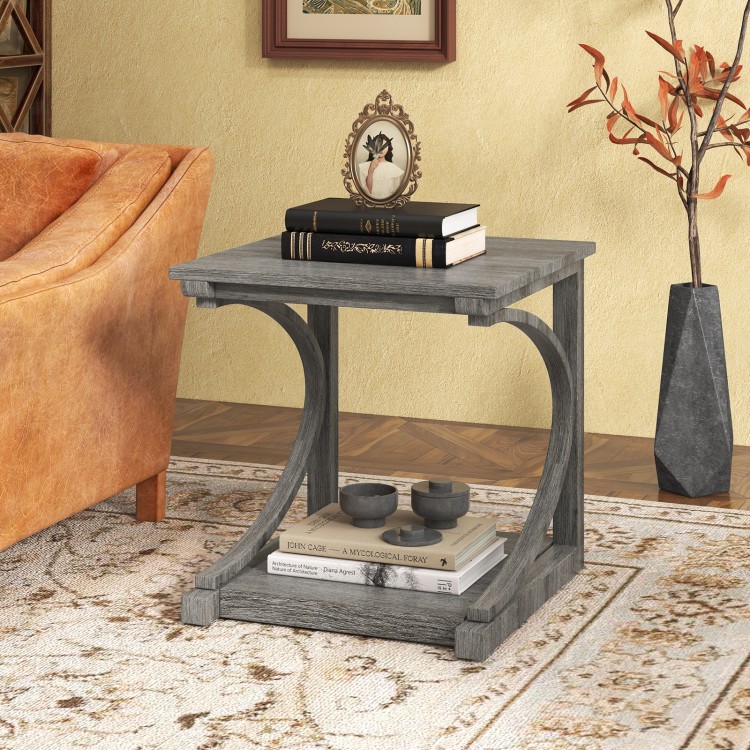 C-shaped grey end table with spacious top and bottom shelf, perfect for lamps and books in a living room setting.