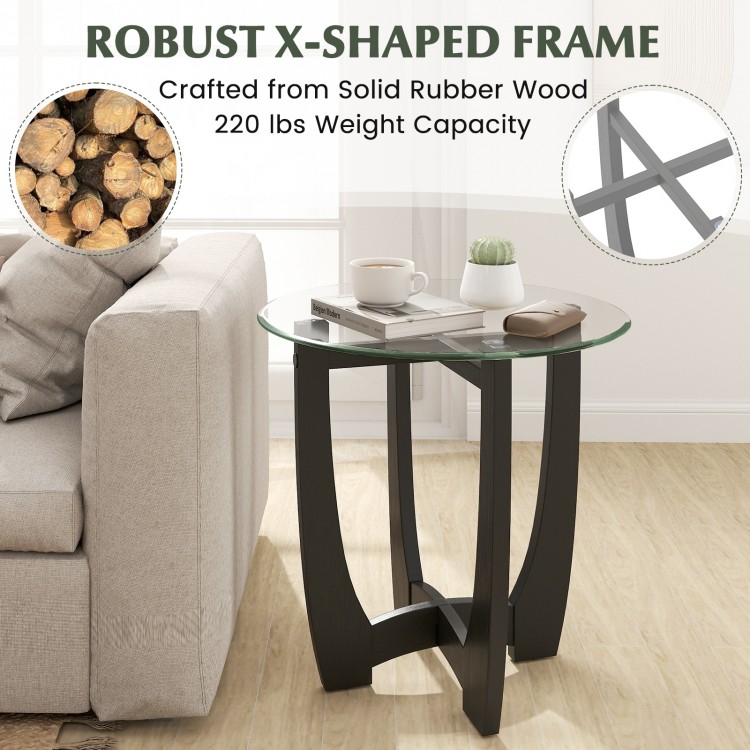 Round end side table with tempered glass top and robust rubber wood X-shaped frame, perfect for contemporary living.