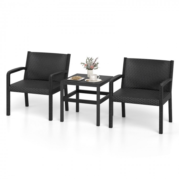 Two black rattan armchairs with a square side table, perfect for outdoor patio use and stylish relaxation.