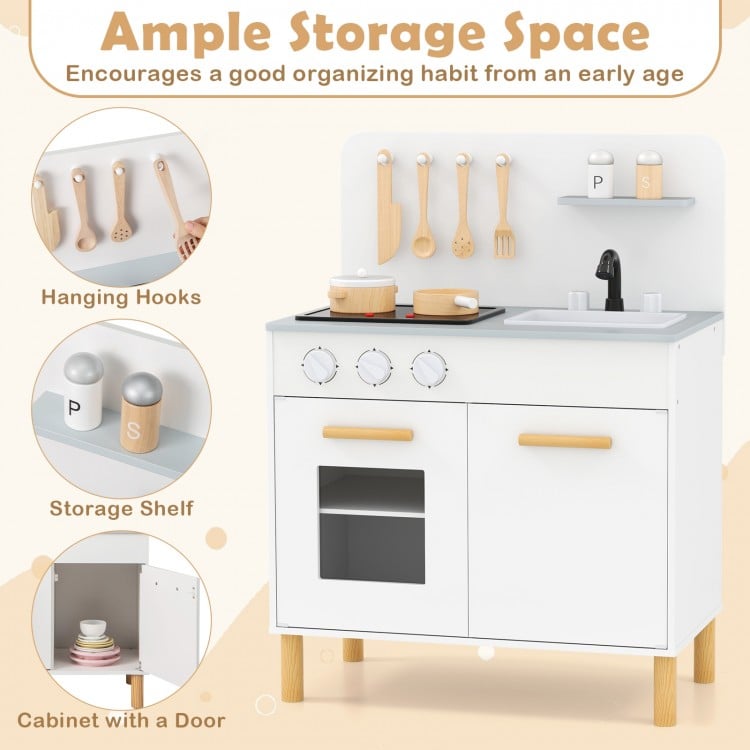 Kids kitchen playset in white with dual stoves, storage shelves, and cooking accessories for imaginative play.