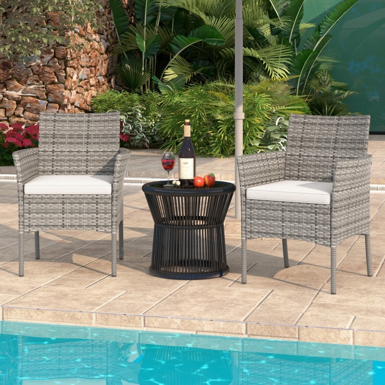 Two outdoor PE rattan armchairs with white cushions, perfect for poolside relaxation and stylish backyard seating.