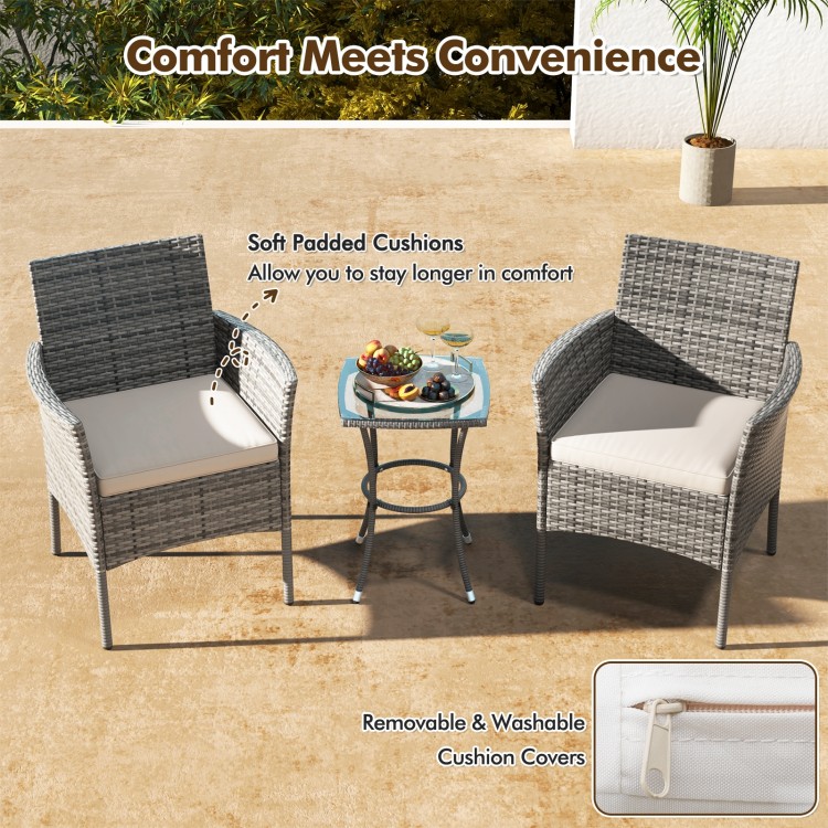 Two outdoor PE rattan armchairs with soft white cushions, perfect for patio relaxation and durable against weather.
