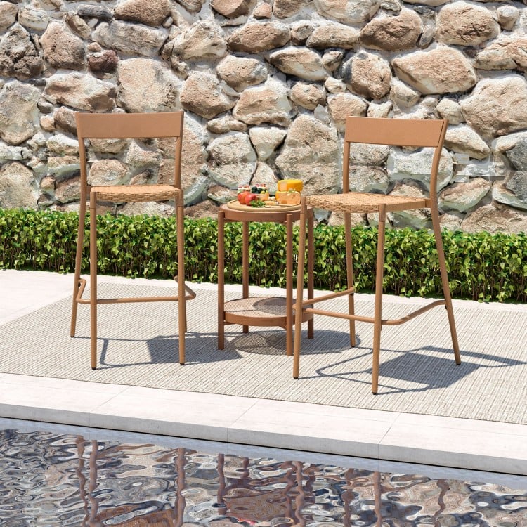 Light brown patio barstools set with rattan seats and metal backrests, perfect for poolside relaxation.