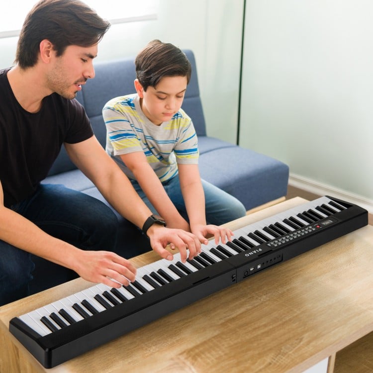 88-key foldable electric keyboard piano in black, featuring dual speakers, ideal for music practice and easy storage.