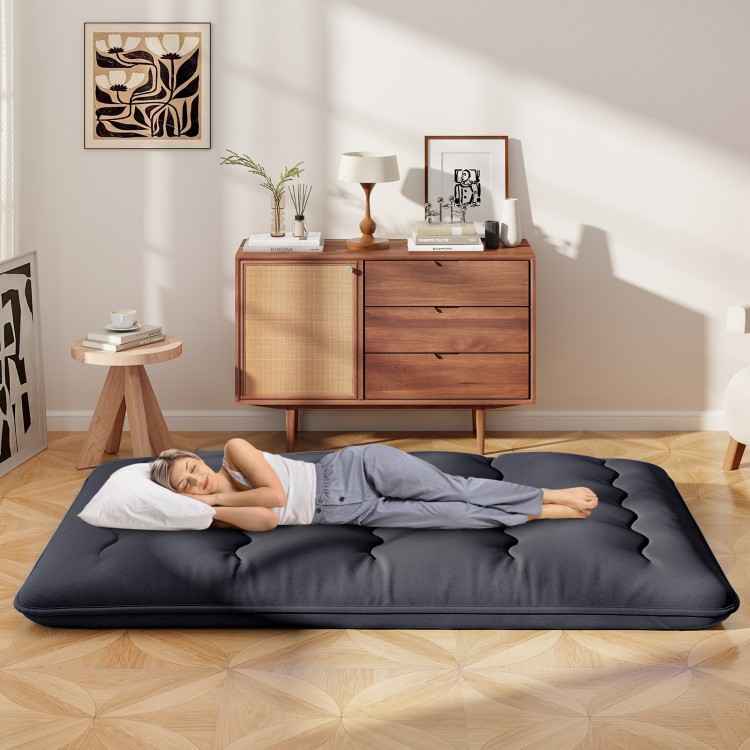 Futon mattress with washable cover, shown in a cozy room, ideal for sleeping, camping, or yoga.