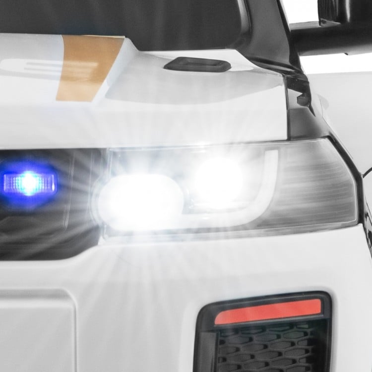 Close-up of the 12V kids ride-on police car's bright LED headlights and siren lights for immersive playtime fun.