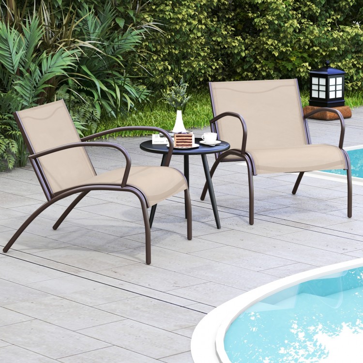 Two Rusic Brown wide armchairs with a side table, perfect for outdoor relaxation by the poolside.