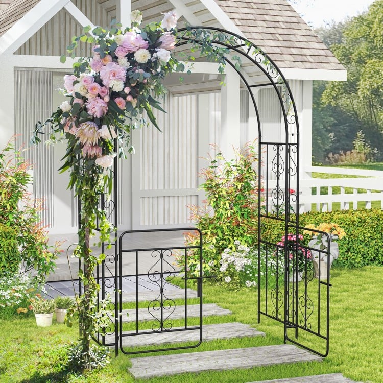 Garden arbor with gate in black, featuring elegant flower decoration and sturdy galvanized metal for outdoor weddings.