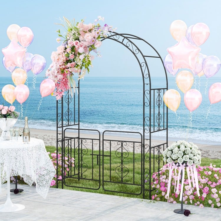 Black garden arbor with gate, featuring elegant flower decorations, ideal for weddings and climbing plants outdoors.