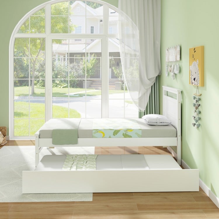 Twin size wooden bed frame with trundle in white, showcasing a clean design and flexible wheels for easy access and use.