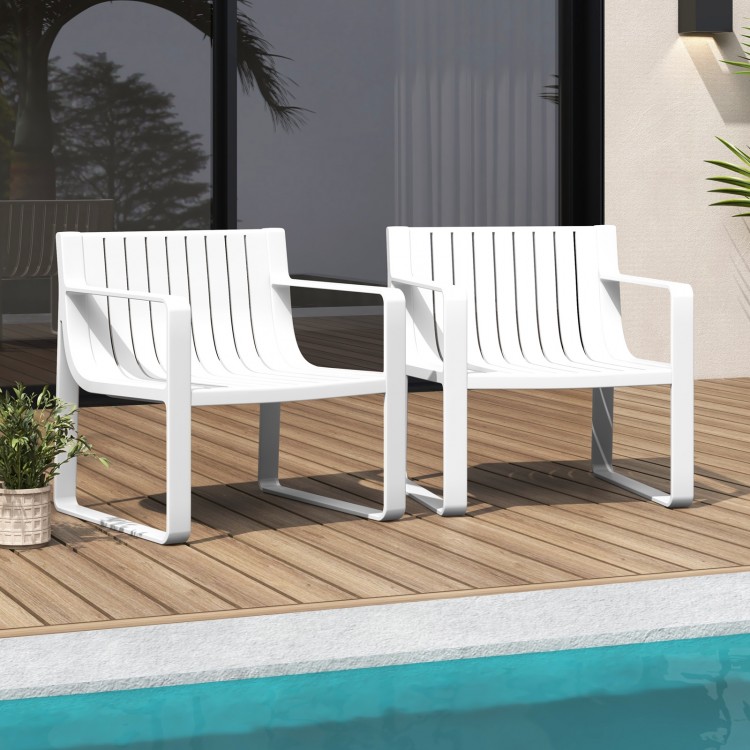 Set of 2 white patio chairs with curved backrests, slatted design, perfect for outdoor relaxation by the poolside.