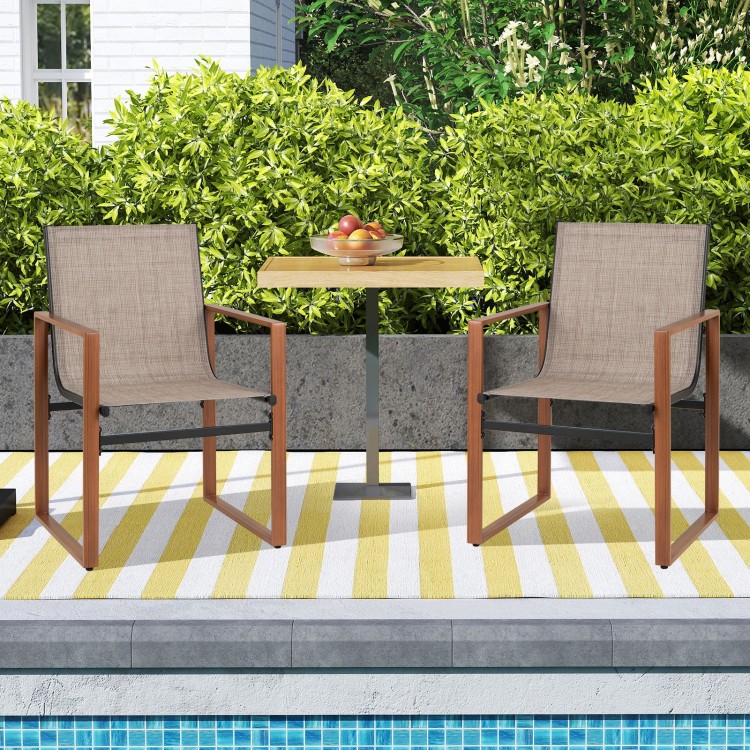 Set of 2 outdoor dining chairs with breathable fabric seats and simulated wood grain armrests, perfect for patio dining.