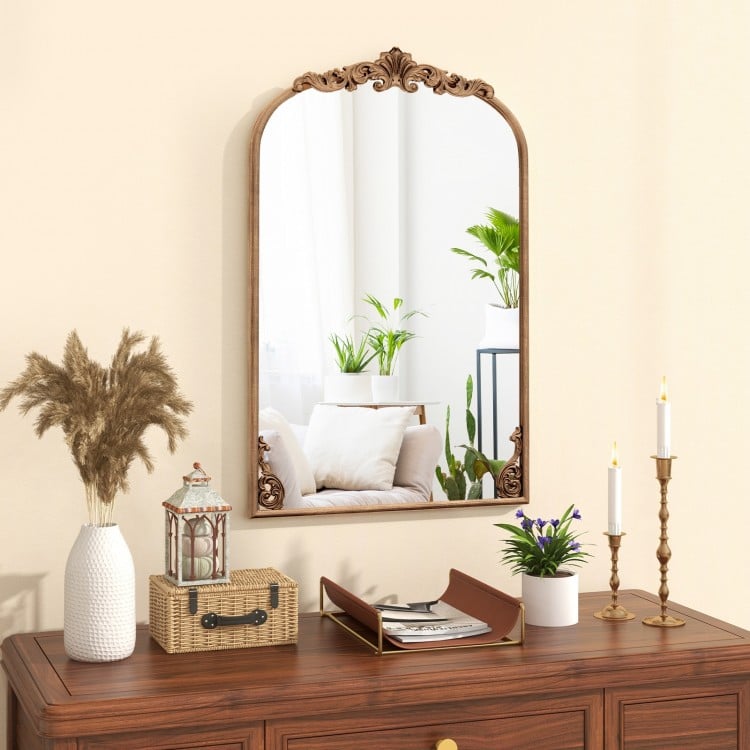 Arched vintage gold metal frame mirror with ornate baroque patterns, perfect for entryways and living rooms.
