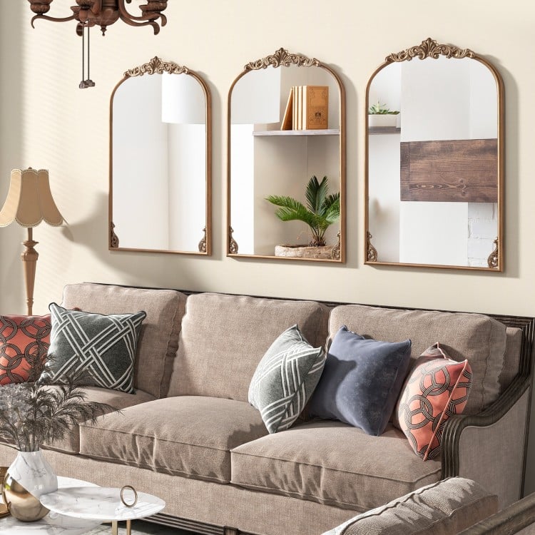 Three arched vintage gold metal frame mirrors with ornate baroque design, perfect for enhancing any living room decor.