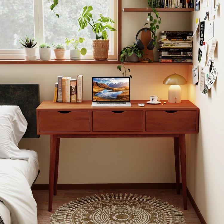 48-inch walnut writing desk with three drawers, solid wood legs, and ample surface for laptop and books in a cozy.