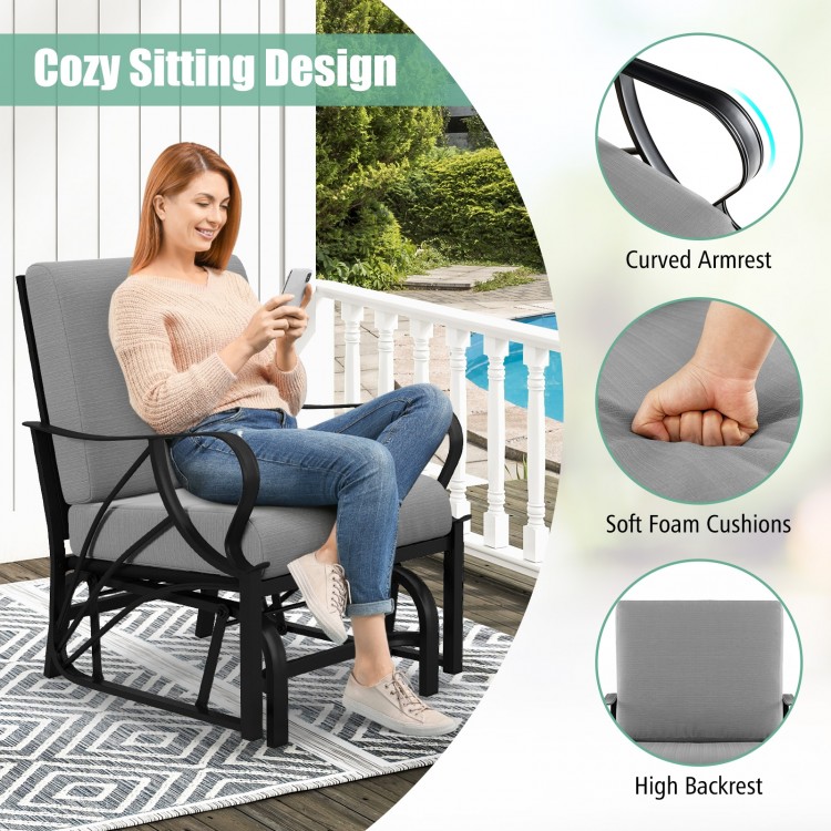 Patio glider rocking chair with gray thick cushion and curved armrest, perfect for outdoor relaxation.