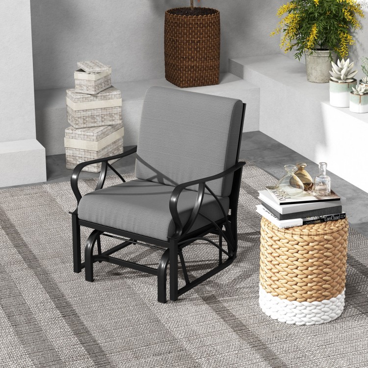 Single gray patio glider rocking chair with thick cushion and stylish curved armrests, ideal for outdoor comfort.