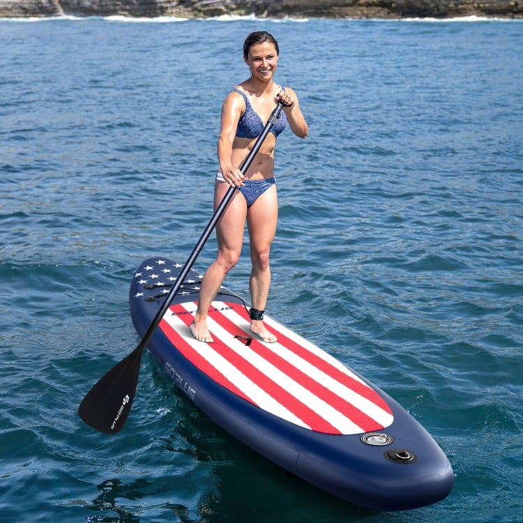 Inflatable paddle board with American flag design, featuring a removable fin and adjustable aluminum paddle for.