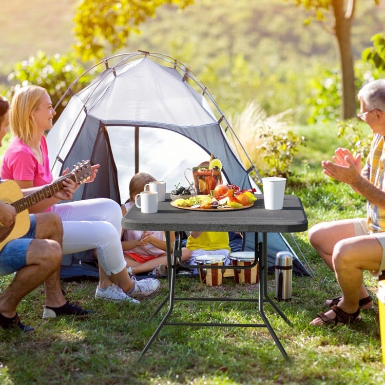 Foldable 2.6FT dining table with wood grain HDPE surface, perfect for camping and picnics, accommodating up to 4 people.