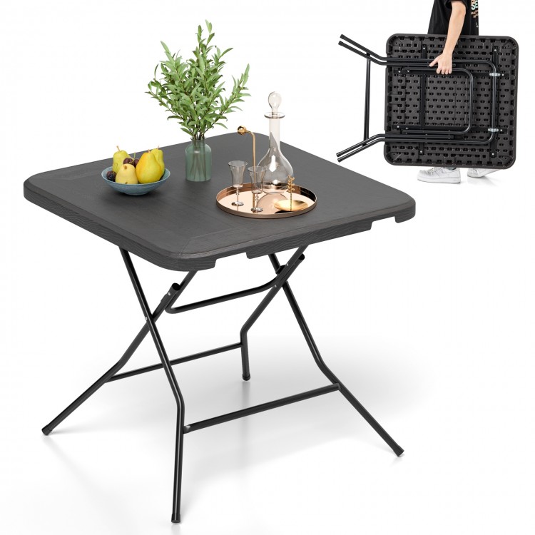 Foldable 2.6FT dining table with wood grain HDPE surface, non-slip foot pads, ideal for indoor or outdoor use.