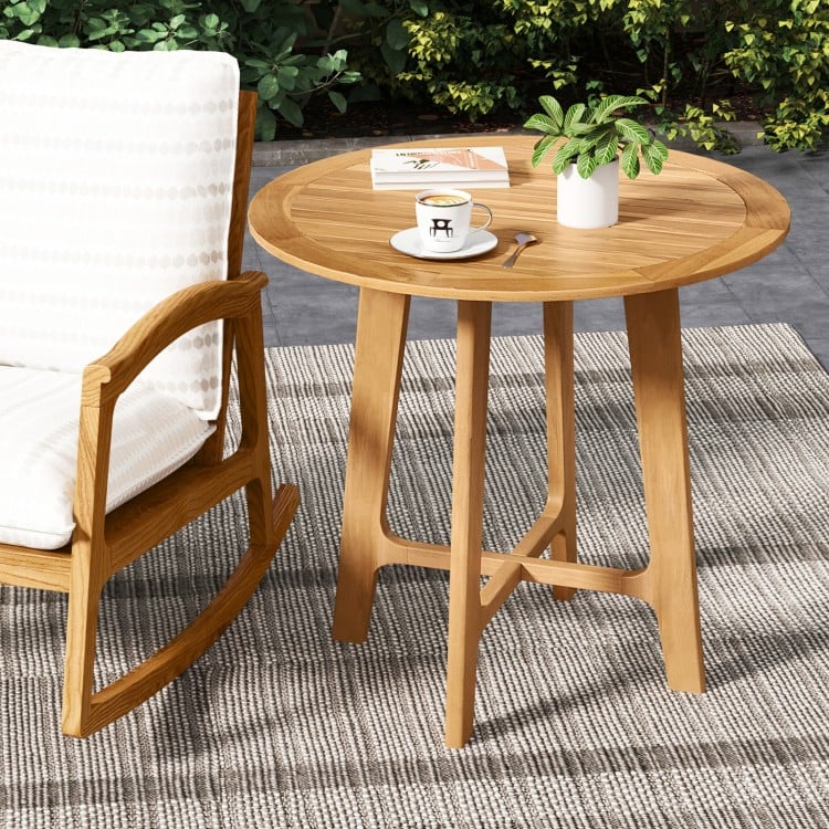 Round 31.5-inch patio dining table with slatted teak wood top and X-shaped frame, perfect for outdoor use.