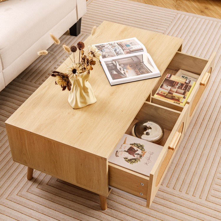 Mid-century modern rattan coffee table with two storage drawers and spacious open compartment for stylish organization.
