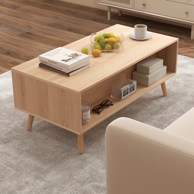 Mid-century modern rattan coffee table featuring an open compartment and natural wood finish, ideal for stylish display.