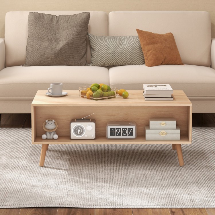 Mid-century modern rattan coffee table featuring a spacious open compartment, perfect for displaying decor and.
