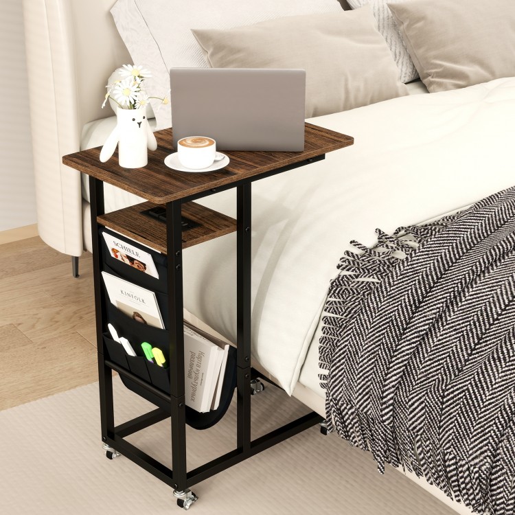 C-shaped end table with rustic wood grain, retractable tabletop, and built-in charging station for bedside convenience.