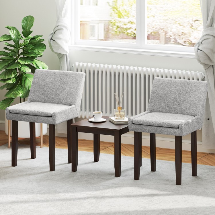 Two gray upholstered chairs with a brown accent table, perfect for kitchen or living room use.