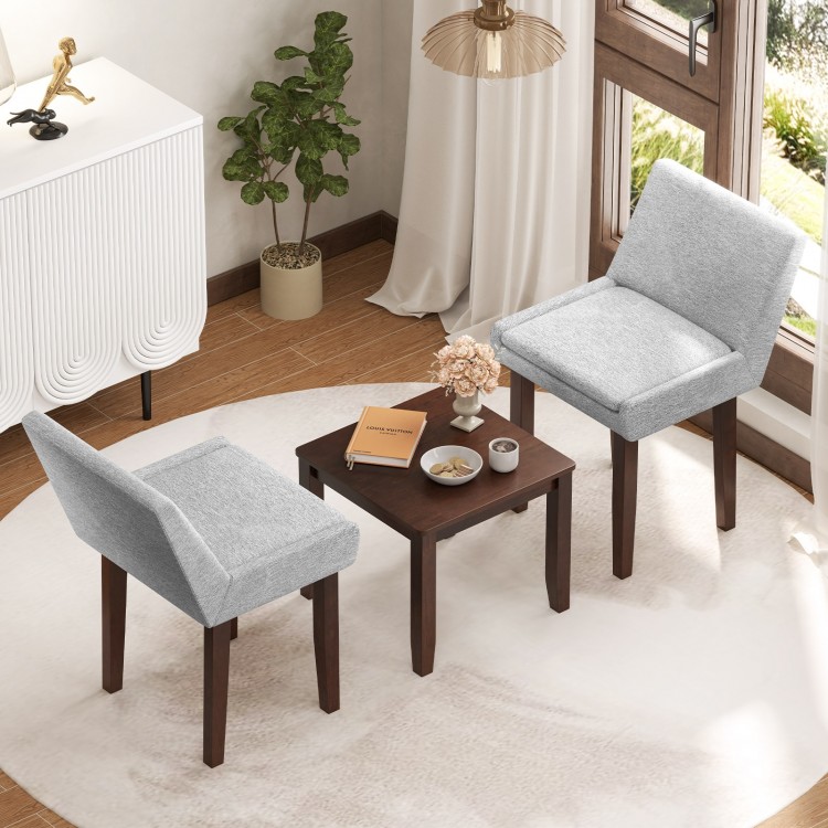 Two gray upholstered chairs with a brown accent table in a cozy living room setting, perfect for kitchen or living room.