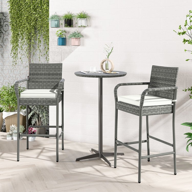 Gray PE rattan patio barstools with armrests and soft cushions, ideal for backyard or poolside relaxation.