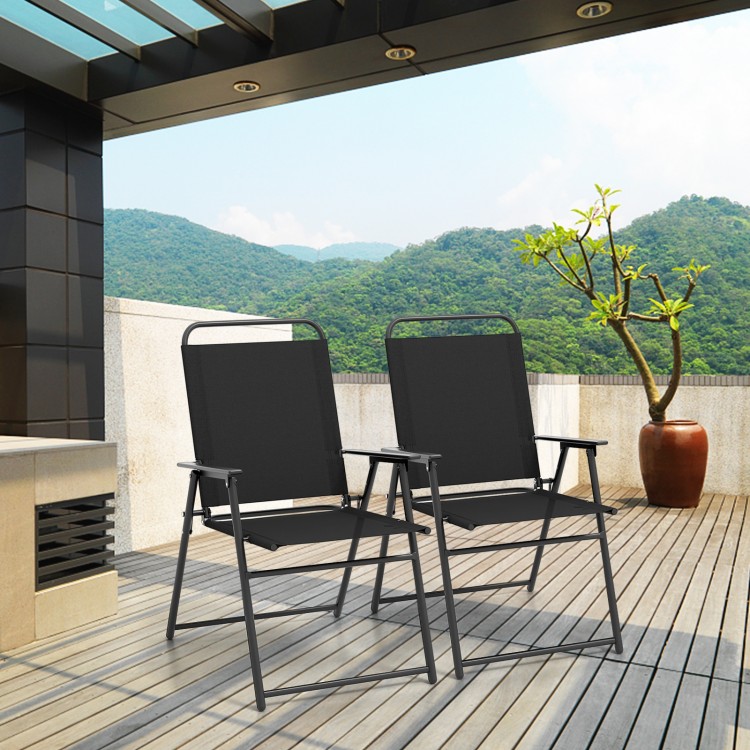 Two black outdoor folding sling chairs with armrests, set on a patio with a scenic mountain view, perfect for.