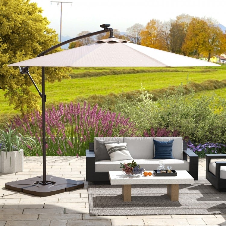 Patio offset umbrella base with detachable plates, made of weather-resistant HDPE plastic, ideal for outdoor use.
