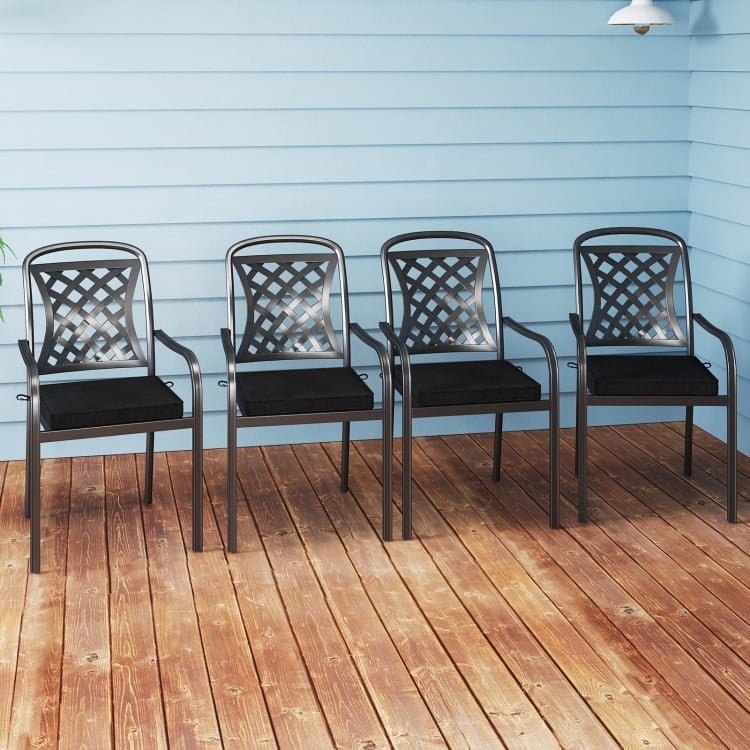 Set of two black outdoor chair cushions made of waterproof olefin fabric, featuring ties for secure attachment.