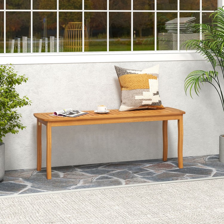 Acacia wood outdoor dining bench with slatted seat, designed for comfort and ventilation, perfect for garden or.