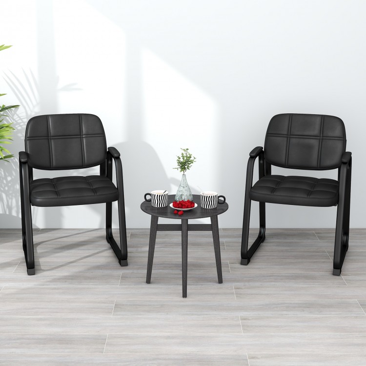 Two black upholstered waiting room chairs with armrests and a round table, ideal for office or living room settings.