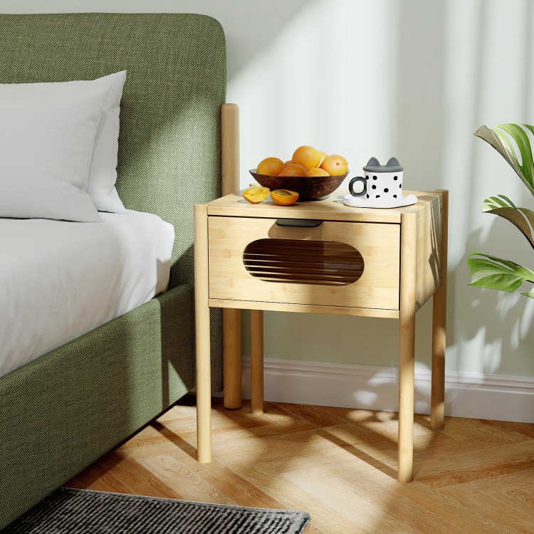 Bamboo nightstand with a decorated drawer, featuring a spacious tabletop and reeded glass, perfect for bedside storage.