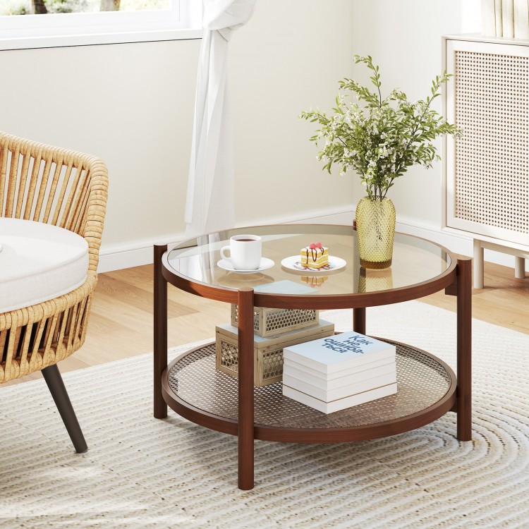 Round coffee table showcasing a tempered glass top and rustic hand-woven rattan shelf, enhancing cozy living room.